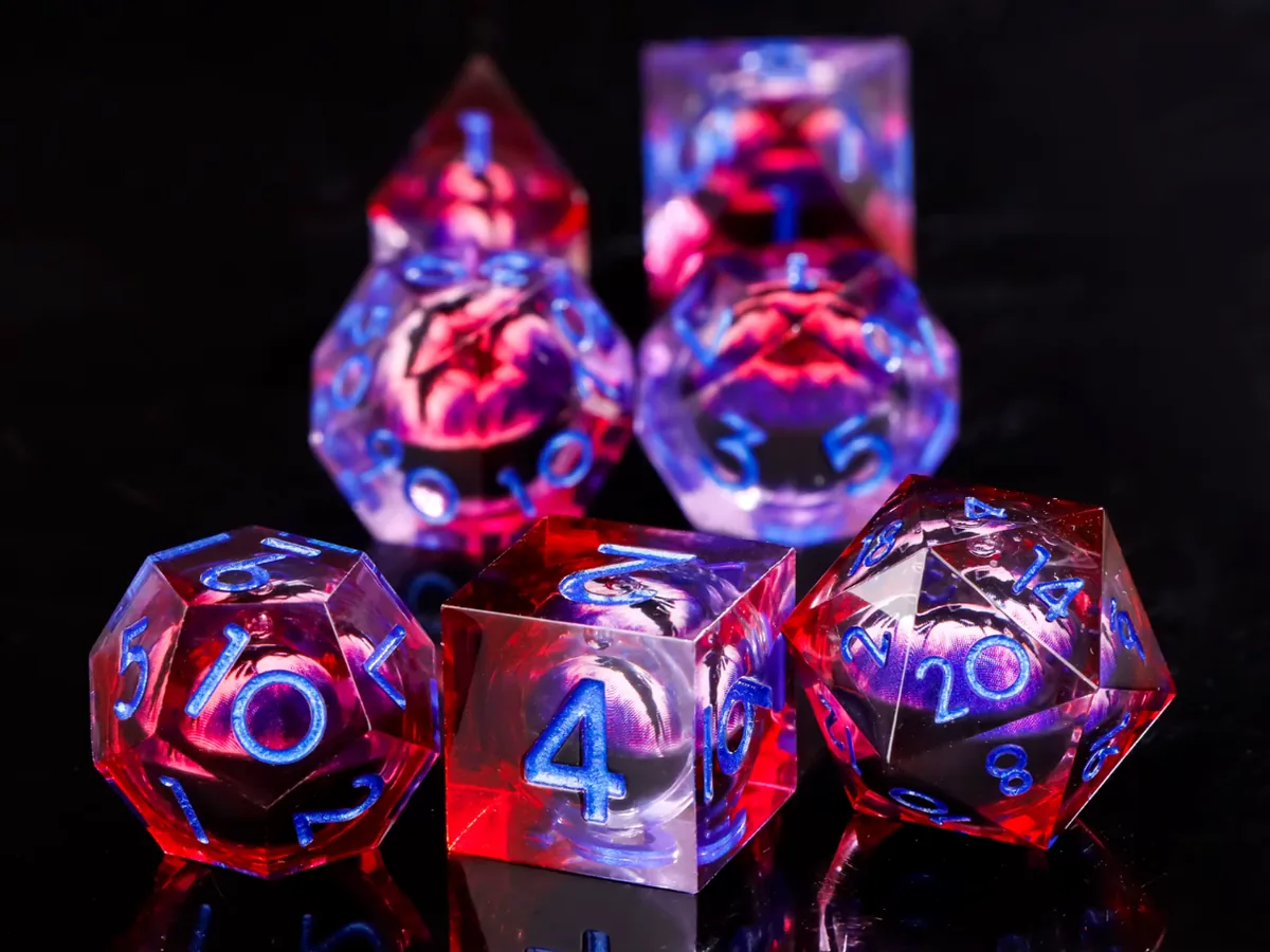 Bloodmoon dice set: seven red and violet resin dice with dragon eyes floating inside, on black glass